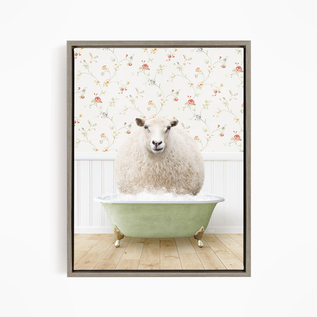 A fluffy white sheep sits in a green bathtub, surrounded by a floral wallpaper.
