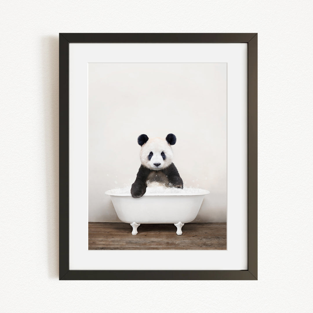 A panda bear sitting in a white bathtub filled with bubbles, creating a playful and whimsical scene.