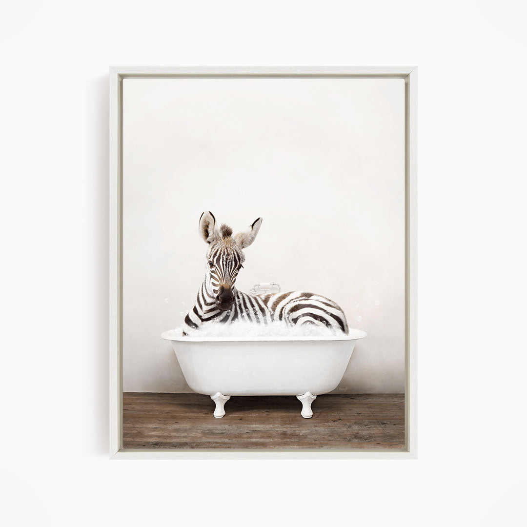 A zebra is sitting in a white bathtub, surrounded by bubbles, creating a whimsical and playful scene.