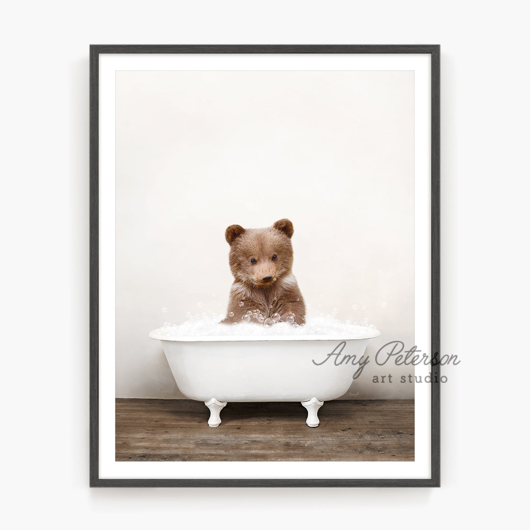 a brown bear sitting in a bath tub