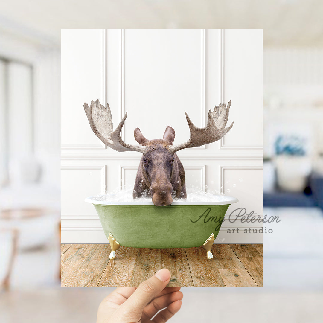 a hand holding up a card with a picture of a moose in a bathtub