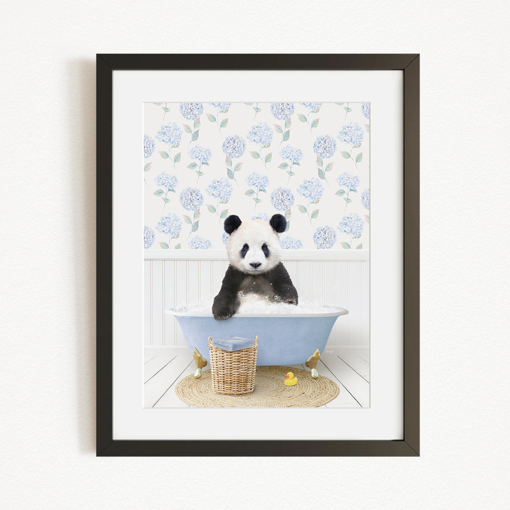 A panda bear sitting in a blue bathtub, surrounded by a floral patterned wall and a basket of rubber ducks.