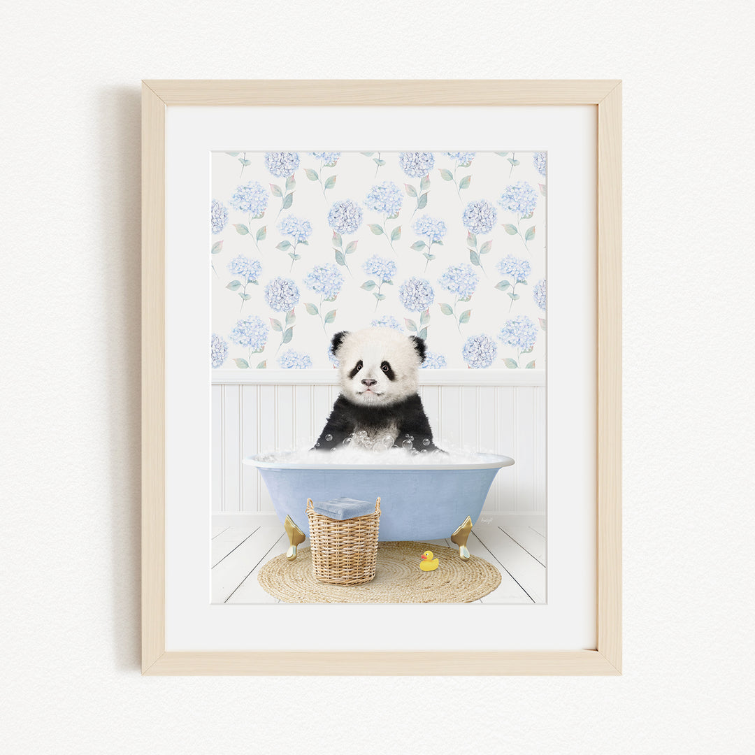 A panda bear sitting in a blue bathtub filled with bubbles, surrounded by a floral patterned wall and a basket of rubber ducks.