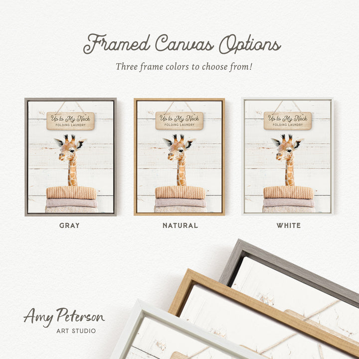 three framed canvas options featuring a giraffe in a folding laundry scene. The options include a gray, natural, and white frame.