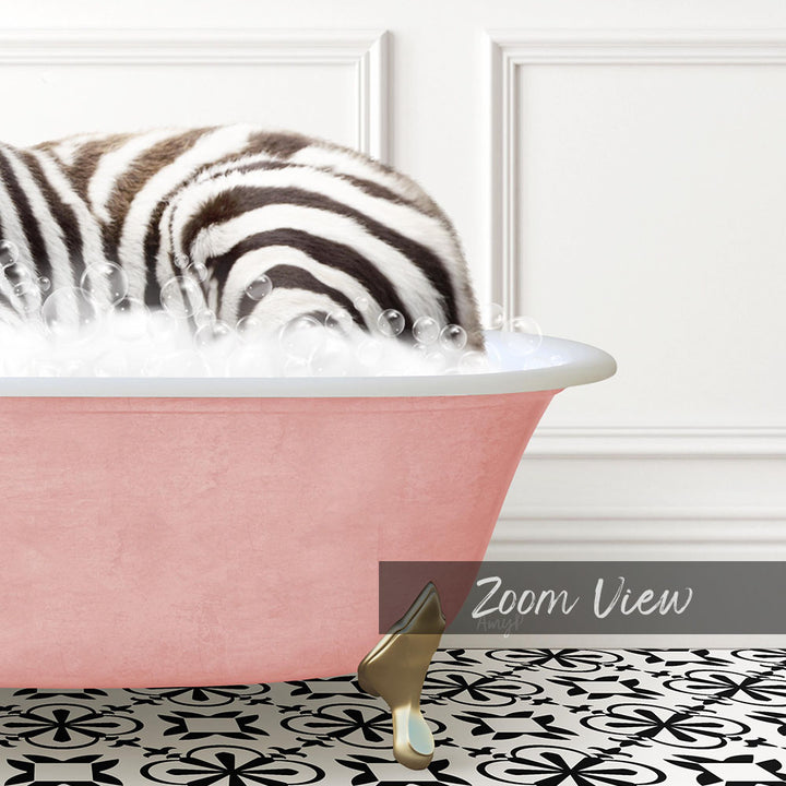 A zebra lying in a pink bathtub filled with bubbles, with a gold comb resting on the floor in front of the tub.