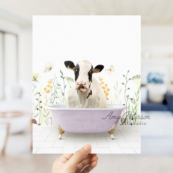 a person holding up a card with a picture of a cow in a bathtub