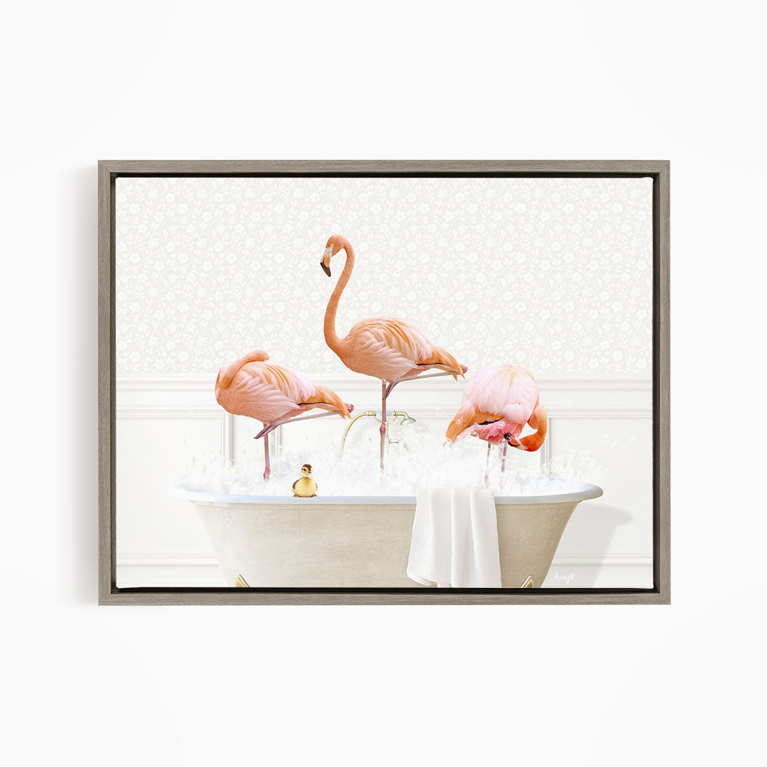 A framed image depicting three pink flamingos standing in a bathtub filled with water and bubbles.
