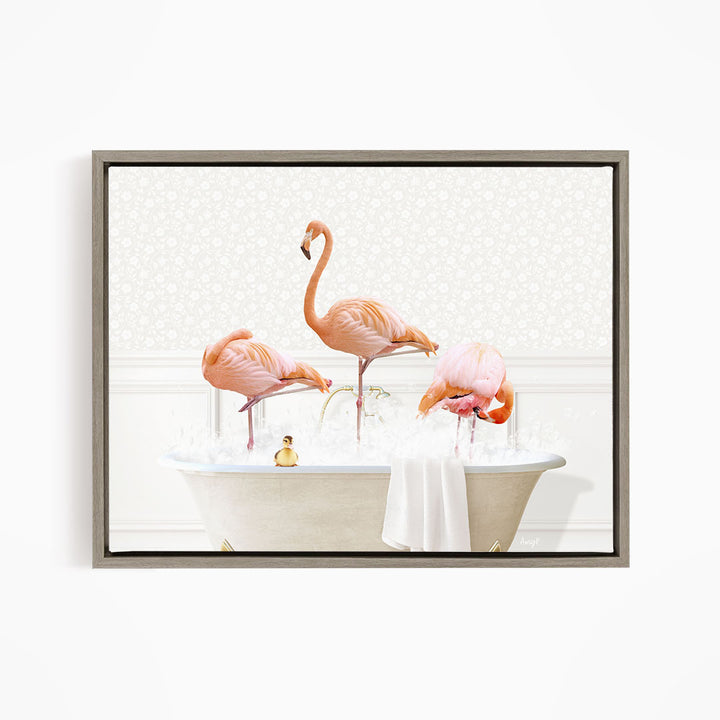 A framed image depicting three pink flamingos standing in a bathtub filled with water and bubbles.