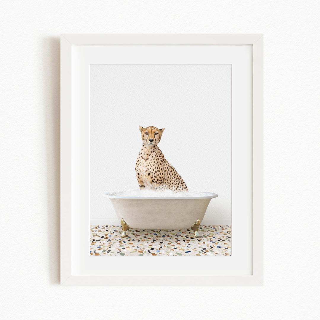 A cheetah sitting in a white bathtub filled with water, with a speckled floor in the background.
