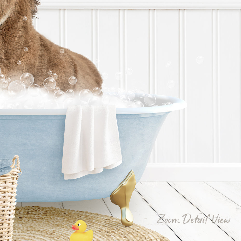A dog is sitting in a blue bathtub filled with bubbles, surrounded by a yellow rubber duck and a white towel.
