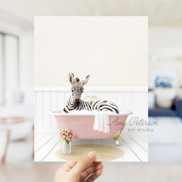 a person holding up a card with a zebra in a bathtub