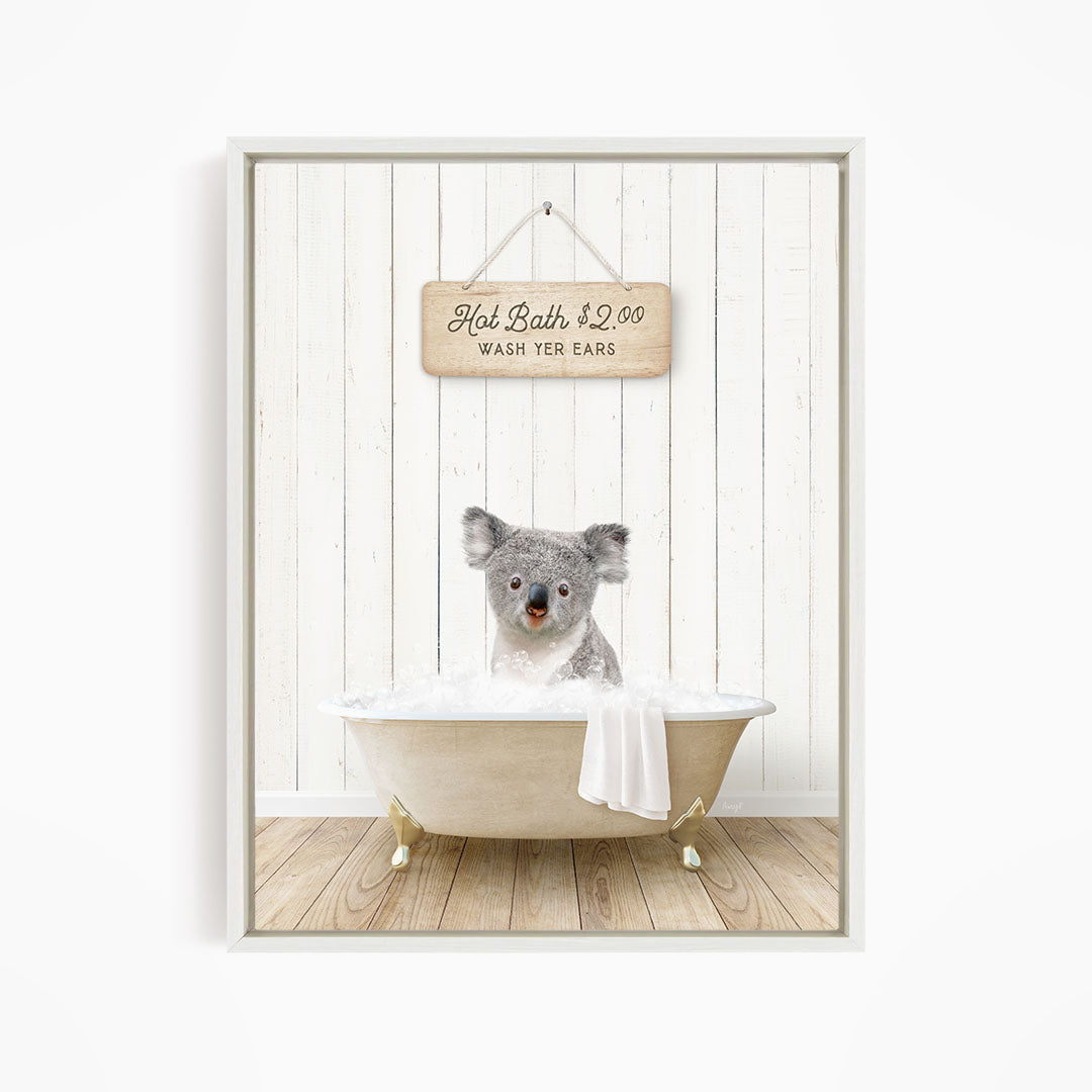 A koala bear sitting in a bathtub, with a sign above that reads "Hot Bath $2.00 WASH YOUR EARS".