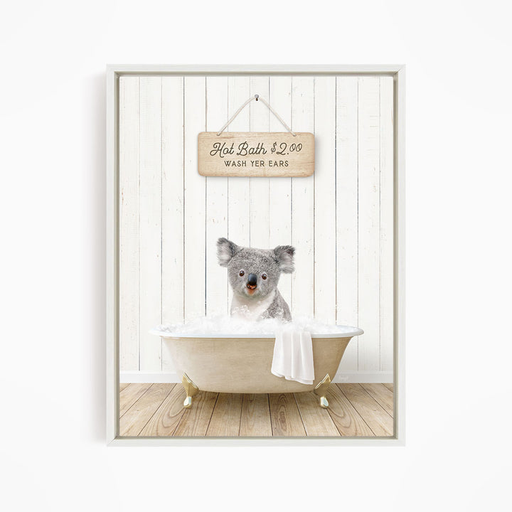 A koala bear sitting in a bathtub, with a sign above that reads "Hot Bath $2.00 WASH YOUR EARS".