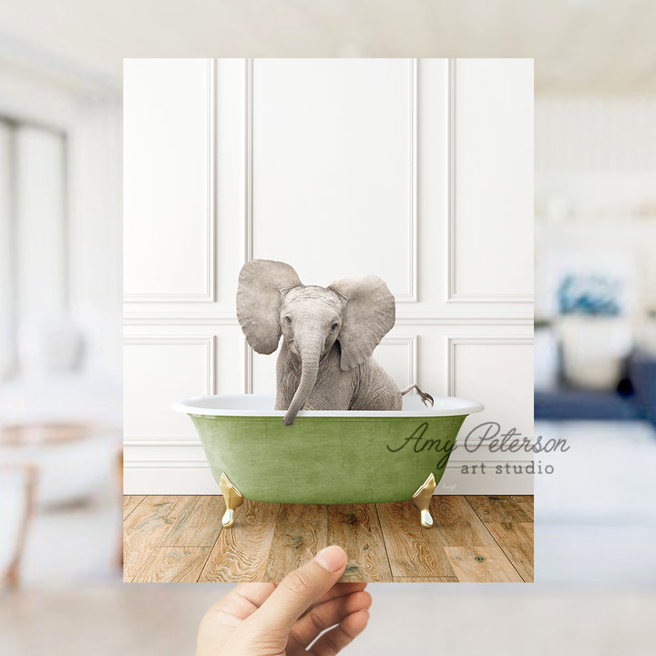 a hand holding a card with a picture of an elephant in a bathtub