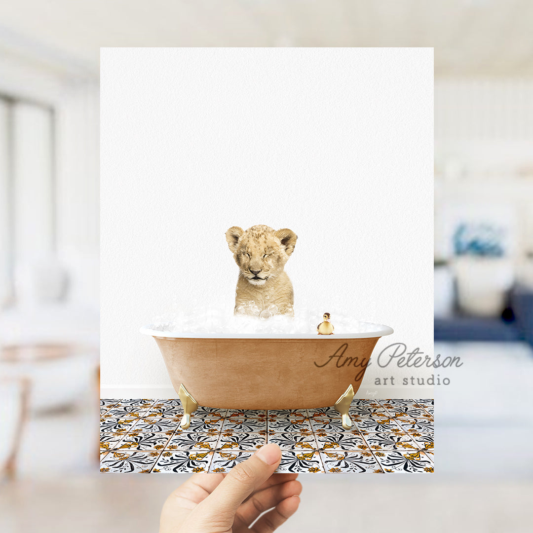 a hand holding a card with a picture of a baby lion in a bathtub