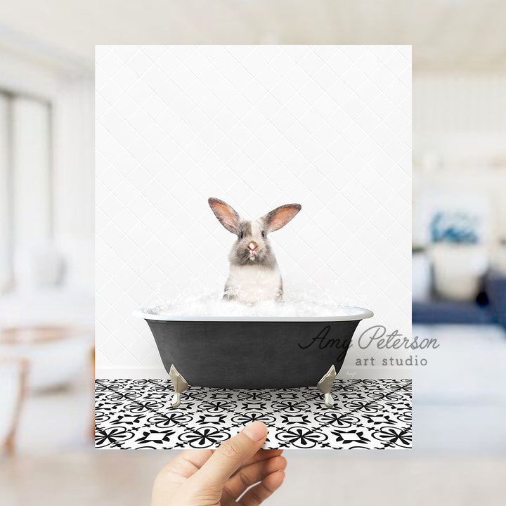 a person holding up a card with a picture of a rabbit in a bathtub