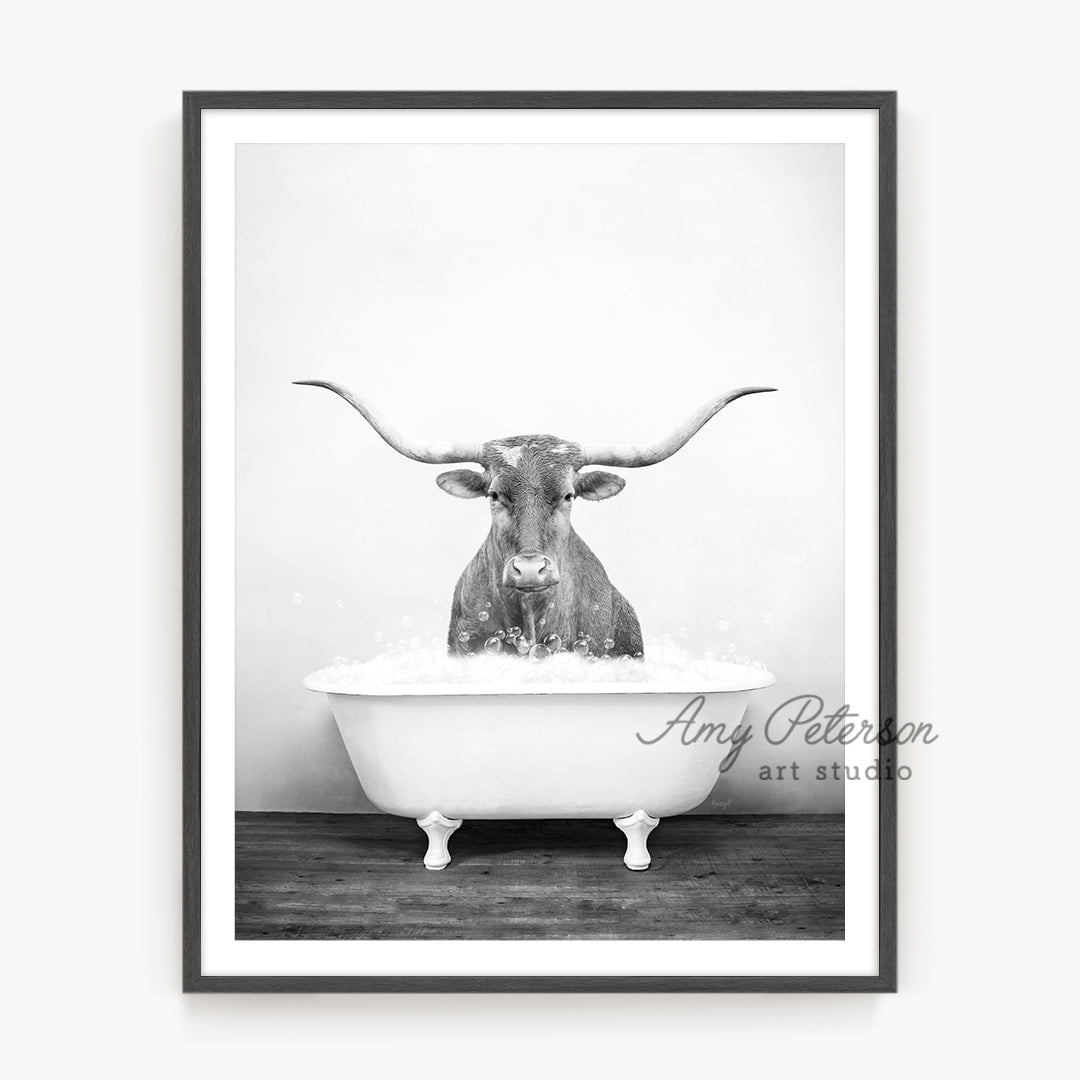 a black and white photo of a bull in a bathtub