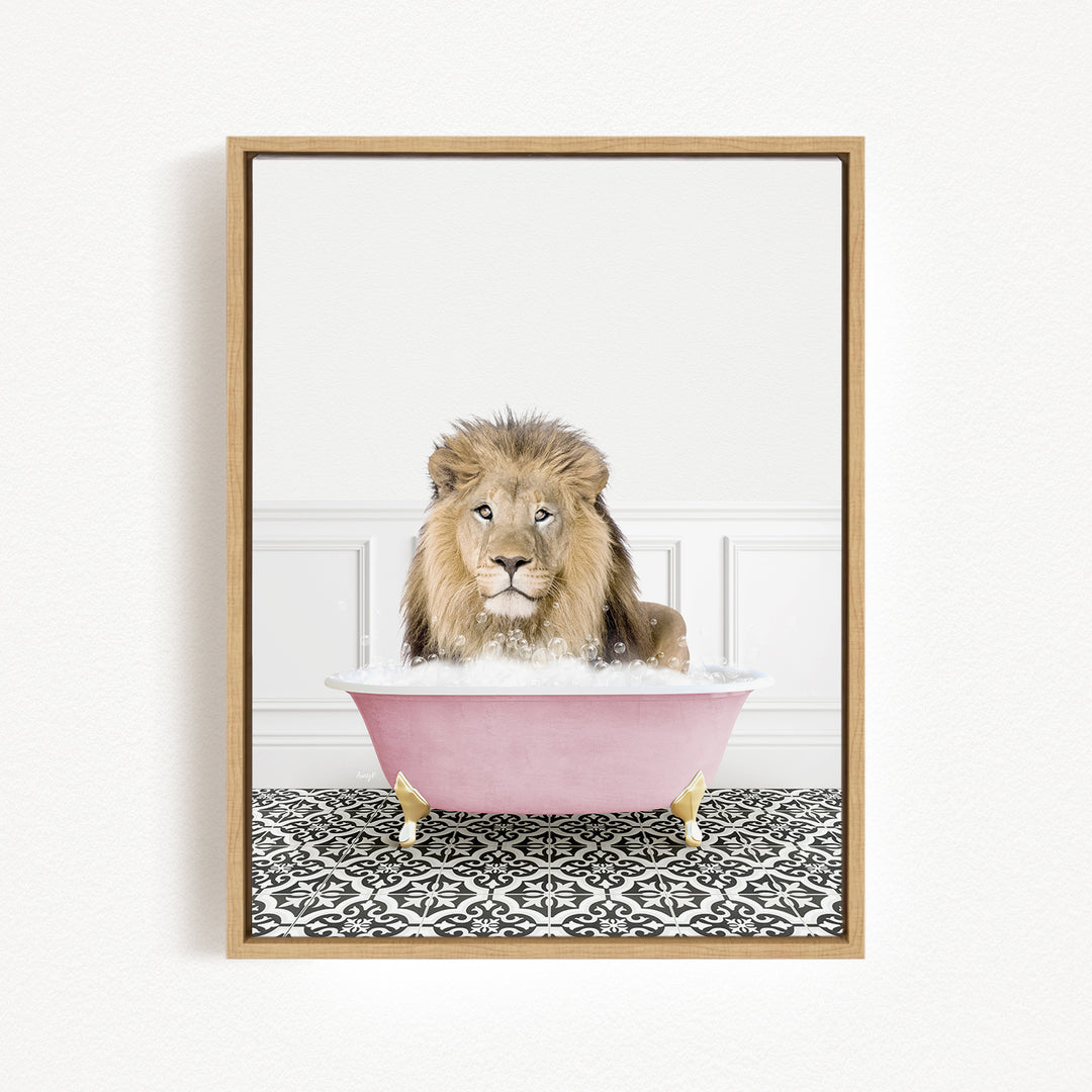 A lion sitting in a pink bathtub filled with bubbles, looking directly at the camera.