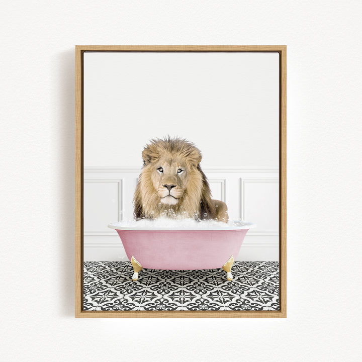A lion sitting in a pink bathtub filled with bubbles, looking directly at the camera.