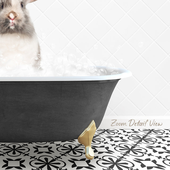 A small rabbit is sitting in a bathtub filled with bubbles, with a patterned tile floor in the foreground.
