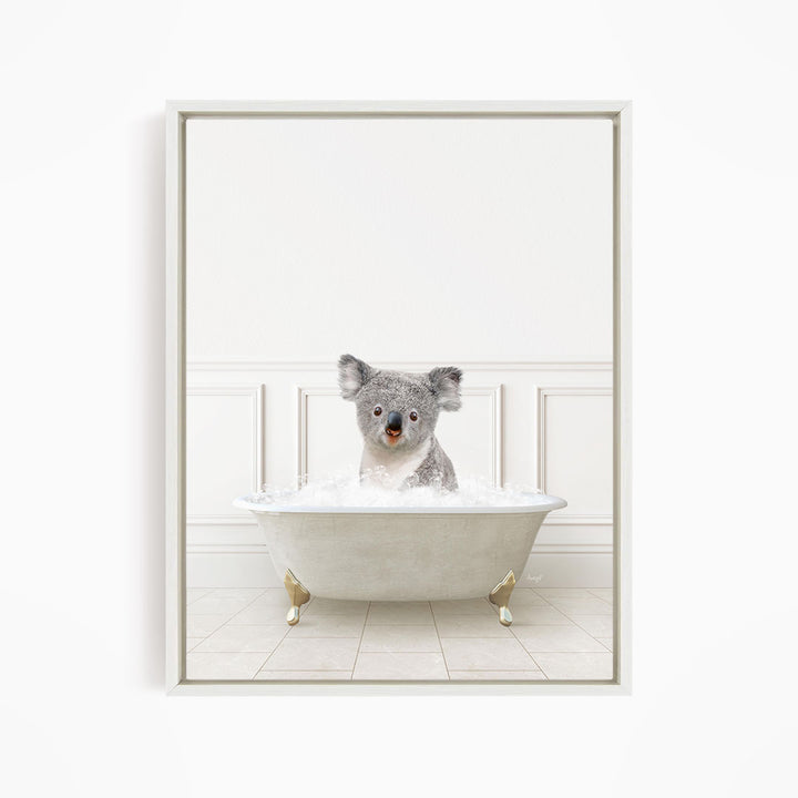 A koala bear sitting in a white bathtub filled with water, looking directly at the camera.