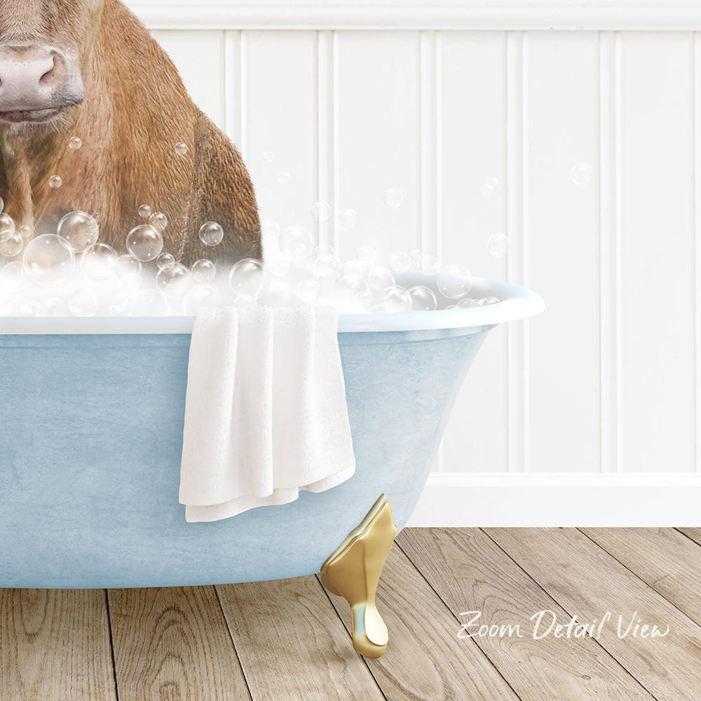 A brown dog is sitting in a blue bathtub filled with bubbles, with a towel and gold bathtub leg visible.