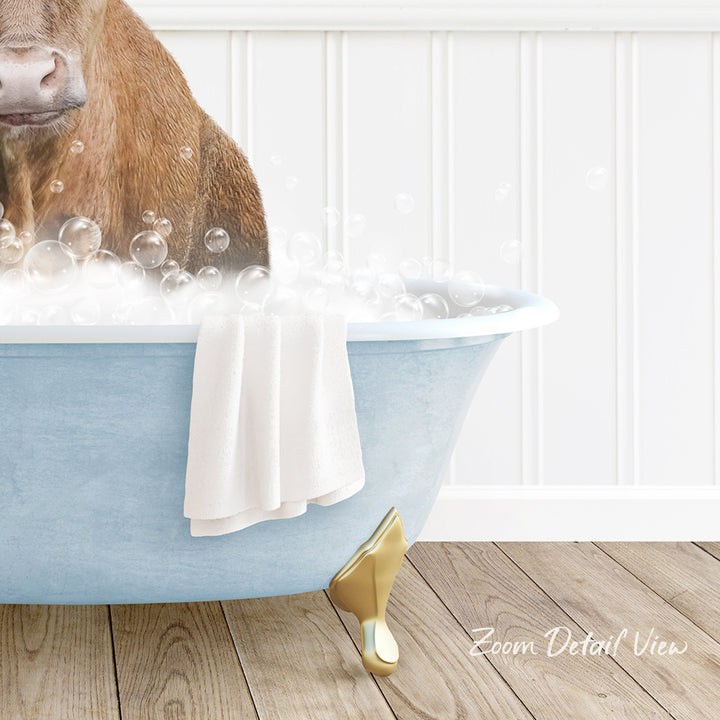 A brown dog is sitting in a blue bathtub filled with bubbles, with a towel and gold bathtub leg visible.