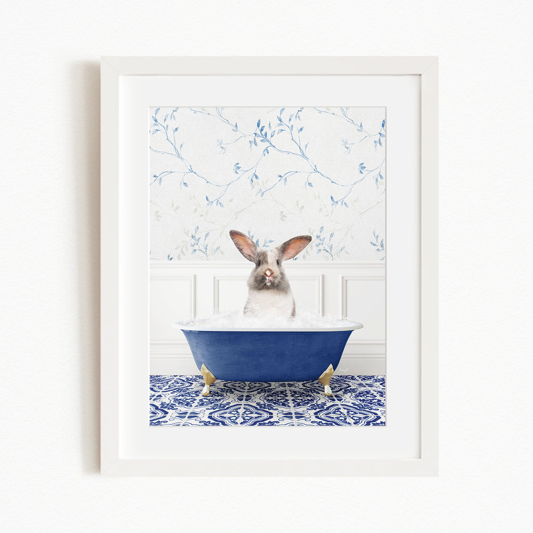A white rabbit sitting in a blue bathtub filled with water, surrounded by a blue and white patterned tile floor.
