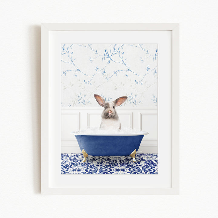 A white rabbit sitting in a blue bathtub filled with water, surrounded by a blue and white patterned tile floor.