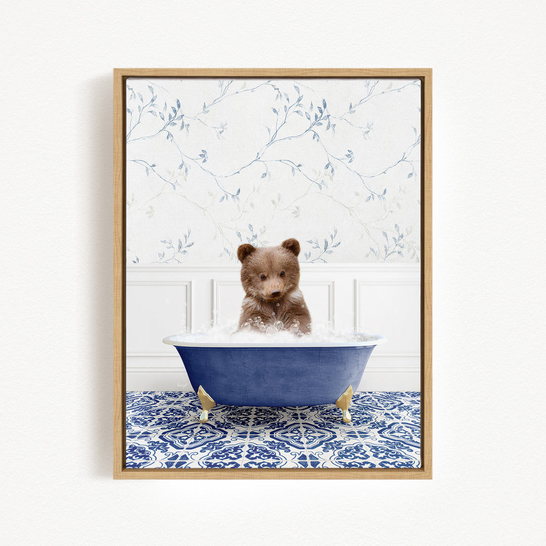 A brown bear sitting in a blue bathtub filled with water, surrounded by a blue and white patterned tile floor.