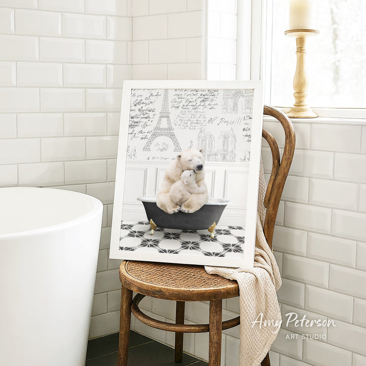 A framed image of two polar bears sitting in a bathtub, with a tiled wall and a window in the background.