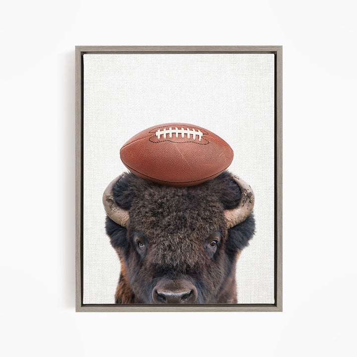 A buffalo with a football resting on its head.