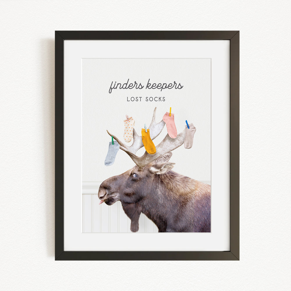 A framed image of a moose with a pile of colorful socks hanging from its antlers.