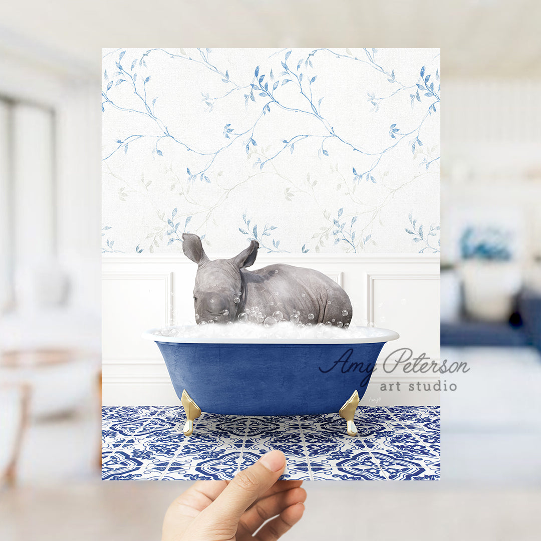 a hand holding a card with a rhino in a bathtub