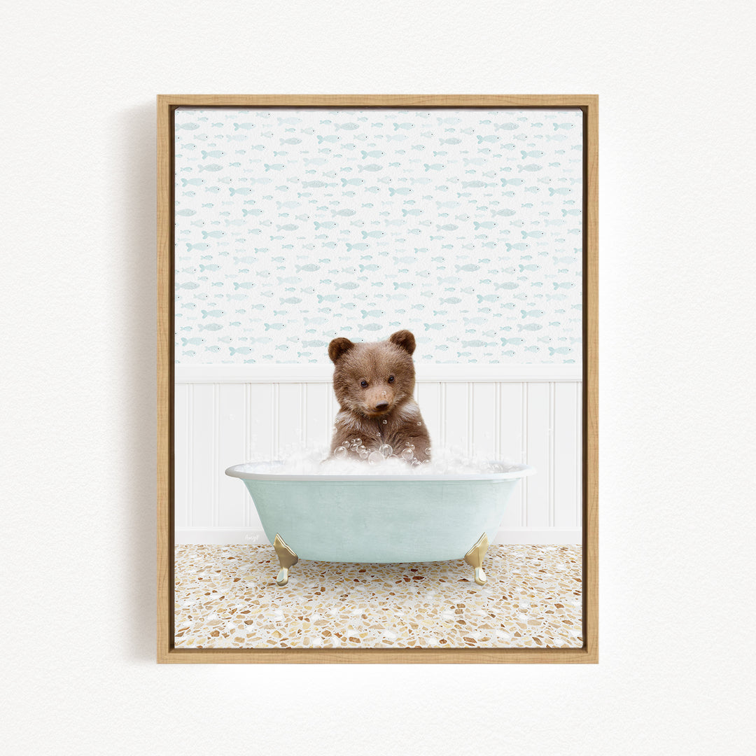 A cute brown bear sitting in a light blue bathtub filled with bubbles, surrounded by a patterned wall and a tiled floor.
