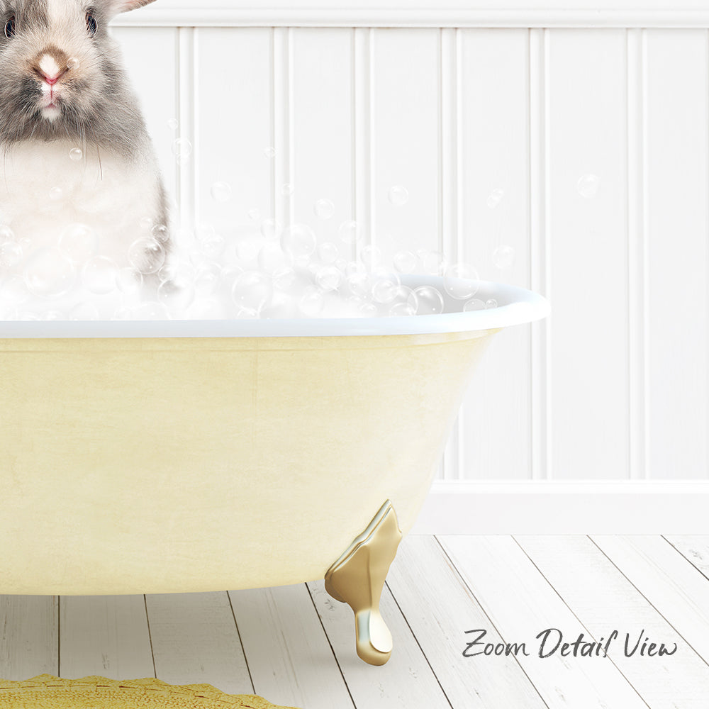 A small rabbit sitting in a yellow bathtub filled with bubbles, with a white wall and wooden floor in the background.