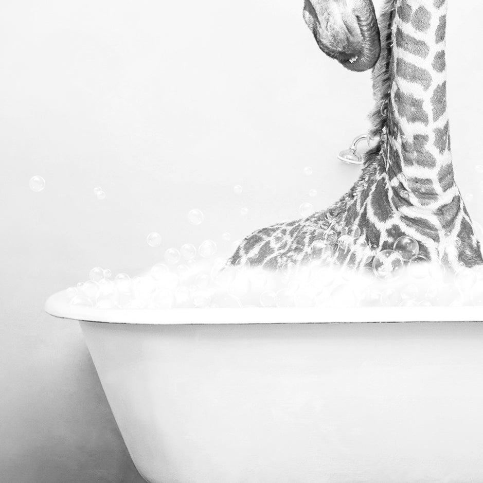 a black and white photo of a baby giraffe in a bathtub