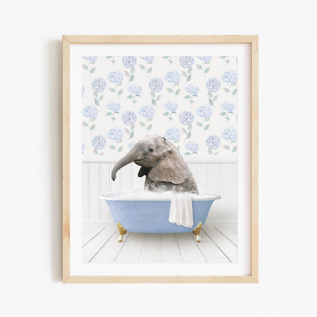 A gray elephant is sitting in a blue bathtub filled with water, surrounded by a floral pattern on the wall behind it.
