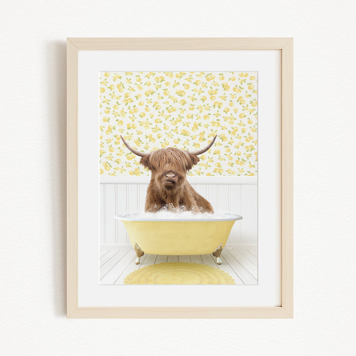 A brown cow with long horns is sitting in a yellow bathtub, surrounded by a yellow floral pattern on the wall behind it.