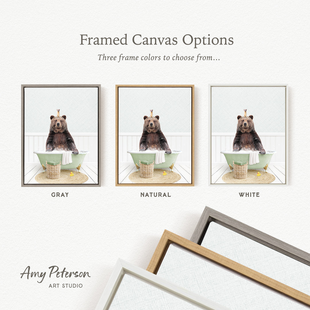 three framed canvas options featuring a bear sitting in a bathtub, each with a different frame color: gray, natural, and white.