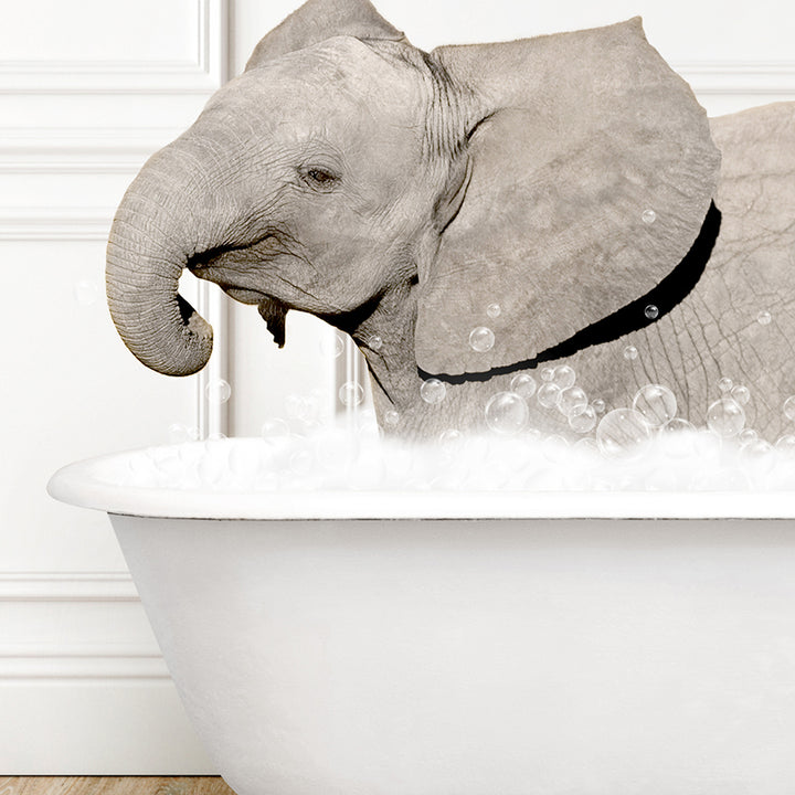 a baby elephant taking a bath in a bathtub