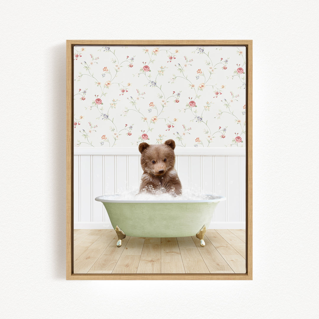 A brown bear sitting in a green bathtub filled with water, surrounded by a floral wallpaper.