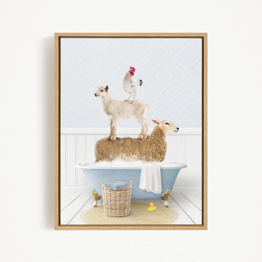 A framed image depicting a sheep standing on a tub filled with water, with a rooster perched on top of it, and a lamb standing on the tub's edge.