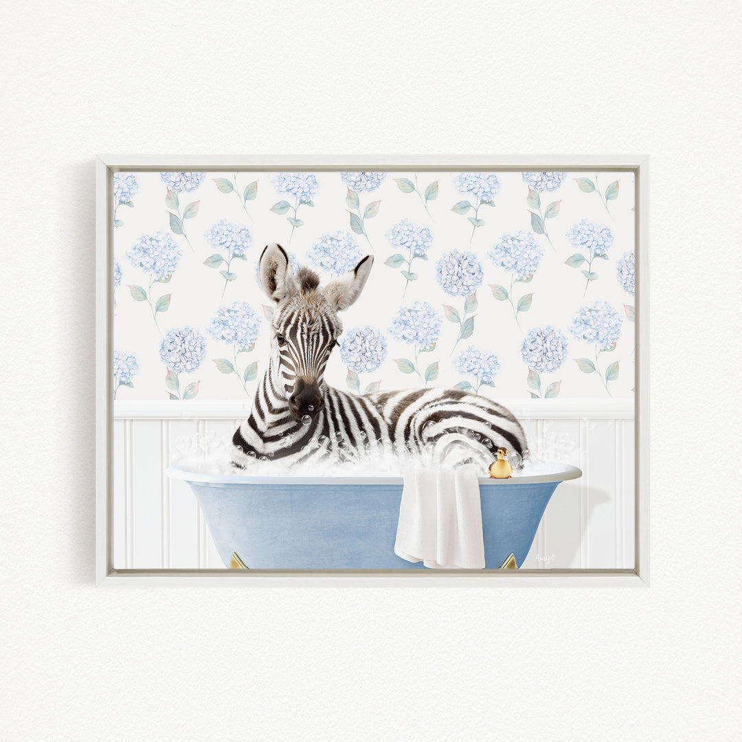 A zebra is sitting in a blue bathtub filled with water, surrounded by a floral pattern on the wall behind it.
