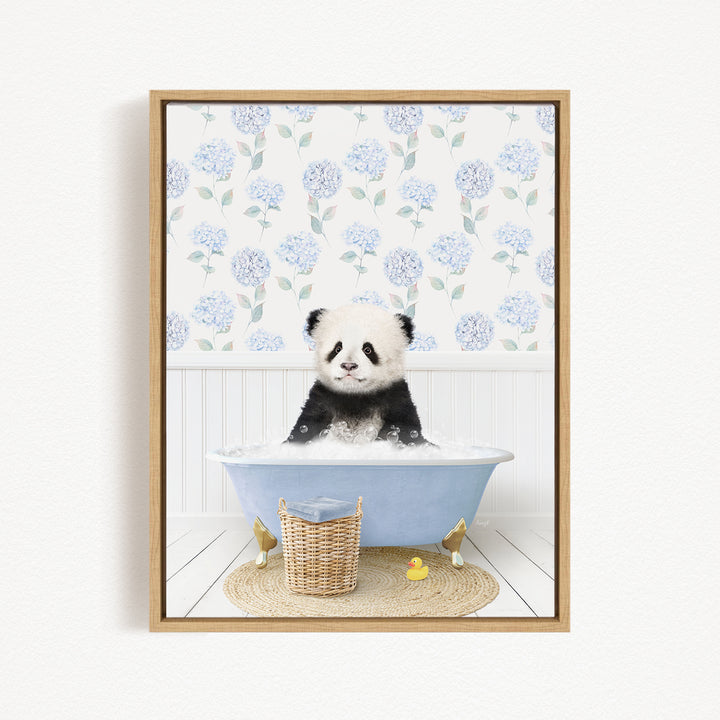 A panda bear sitting in a blue bathtub filled with water, surrounded by a wicker basket and rubber duckies.