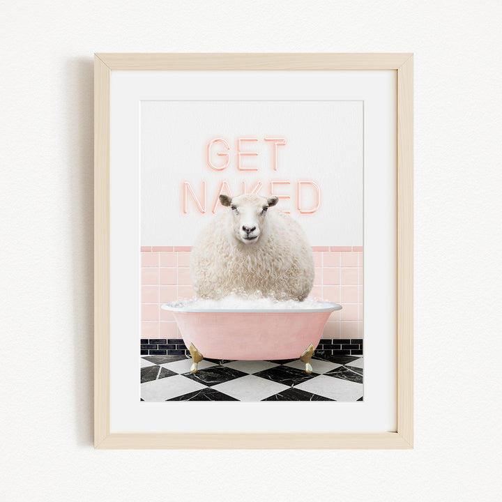 A framed image depicting a fluffy white sheep sitting in a pink bathtub, with the text "GET NAKED" displayed above it.