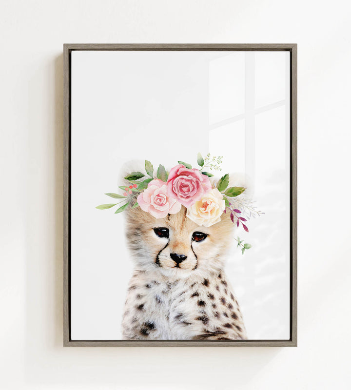 A cheetah wearing a floral crown of pink and white roses and greenery.