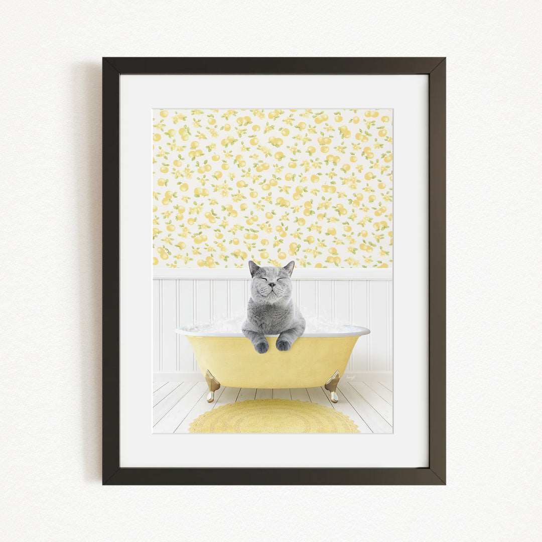 A gray cat sitting in a yellow bathtub, with a yellow floral wallpaper in the background.