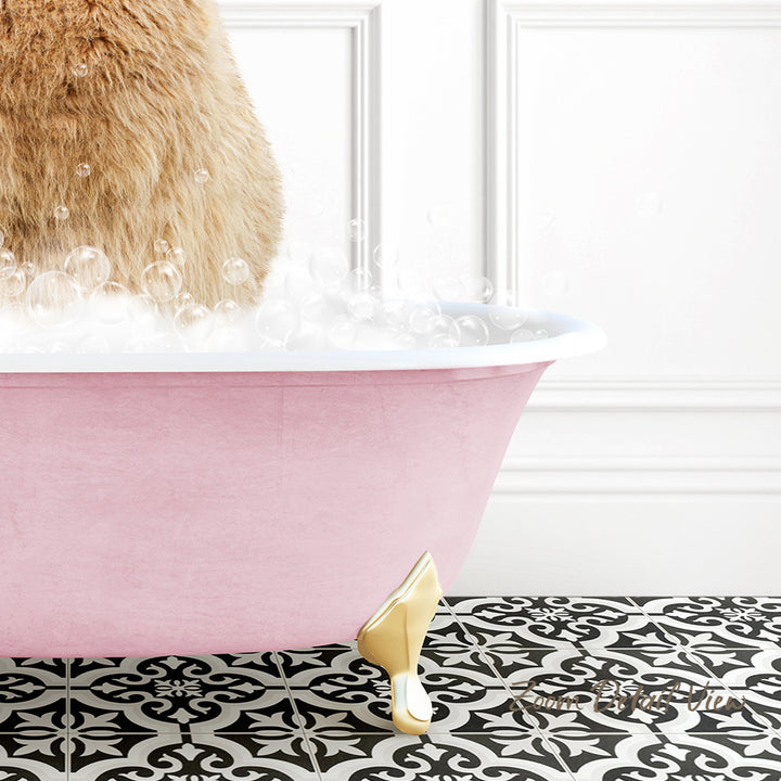A pink claw-foot bathtub filled with bubbles, with a cat standing inside it.