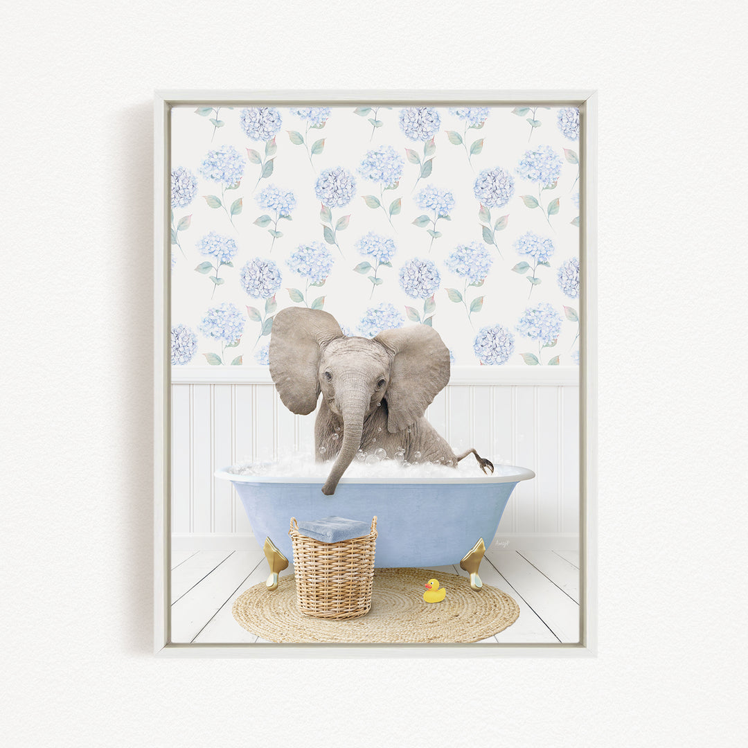 A gray elephant is sitting in a blue bathtub filled with water, surrounded by a wicker basket and a yellow rubber duck.